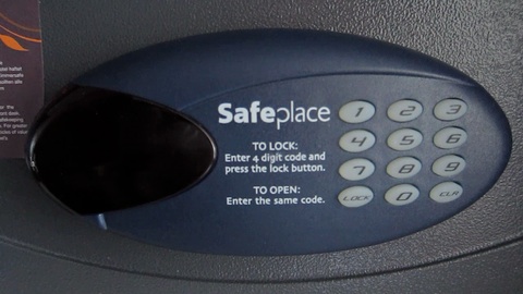Entering a code into the safe, followed by the safe locking itself