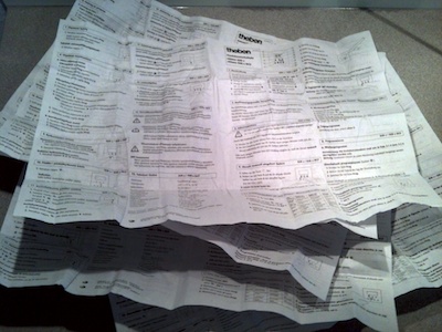 Stack of unfolded individual paper sheets making up the user manual