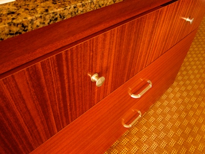 Front of the TV console dresser with three drawers, the top one of which sports two knobs
