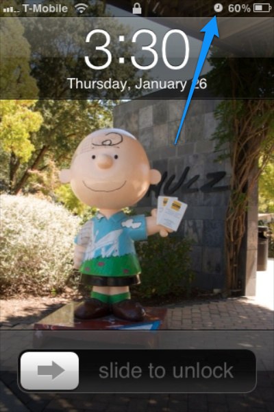 Screen of a locked iPhone, with an arrow highlighting the 
