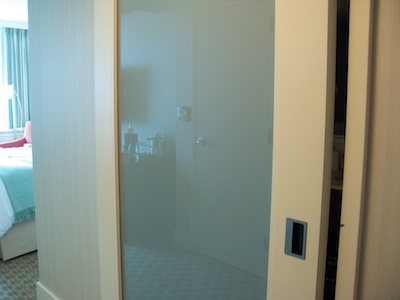 Sliding bathroom door with frosted-glass panel and recessed handle