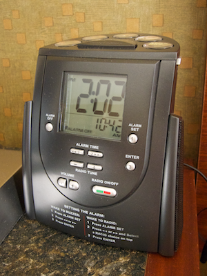 Hilton radio alarm clock on a hotel room nightstand