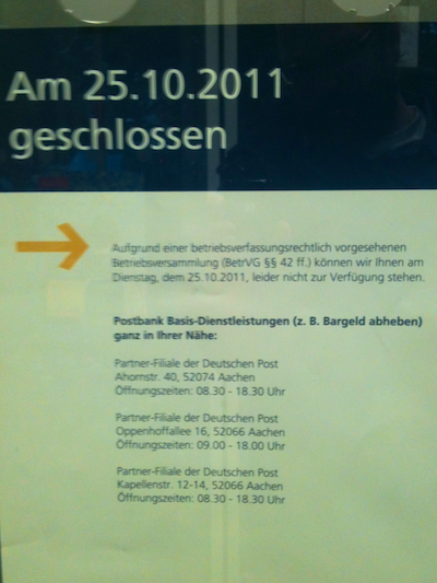 Poster mounted on a door, stating that the post office is closed for the day