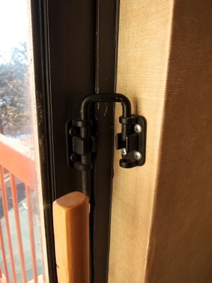 Lock on balcony sliding door, consisting of two brackets connected by a U-shaped bolt