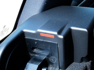 Trunk cover mounting bracket with a red bar on its inside surface.