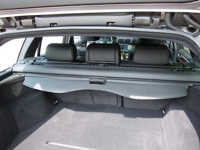 Station wagon's trunk with retracted trunk cover.